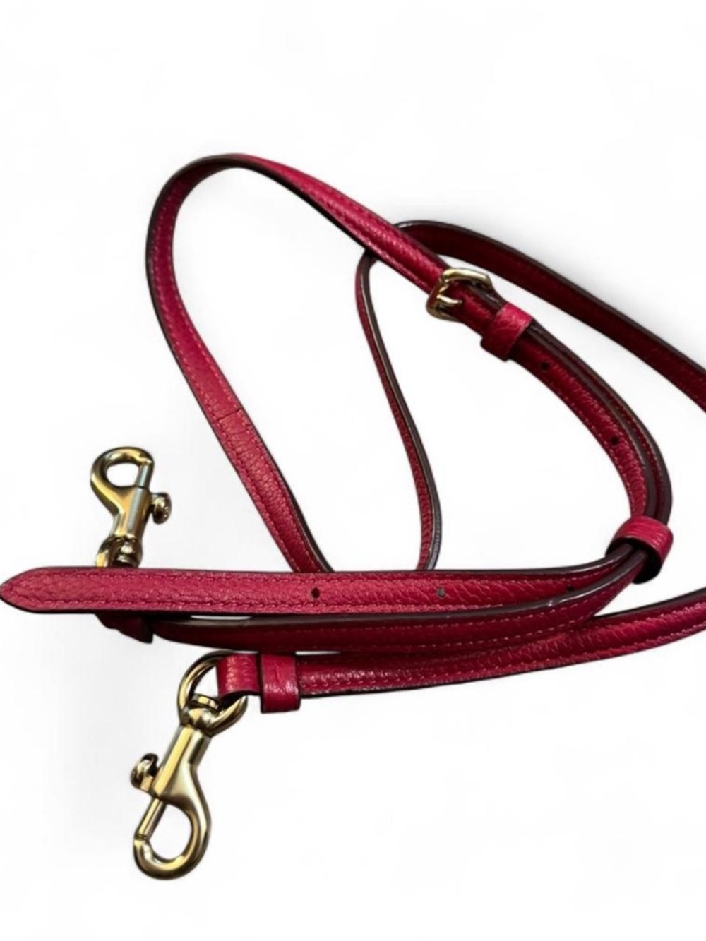 Cherry-toned Coach adjustable strap with soft gold hardware